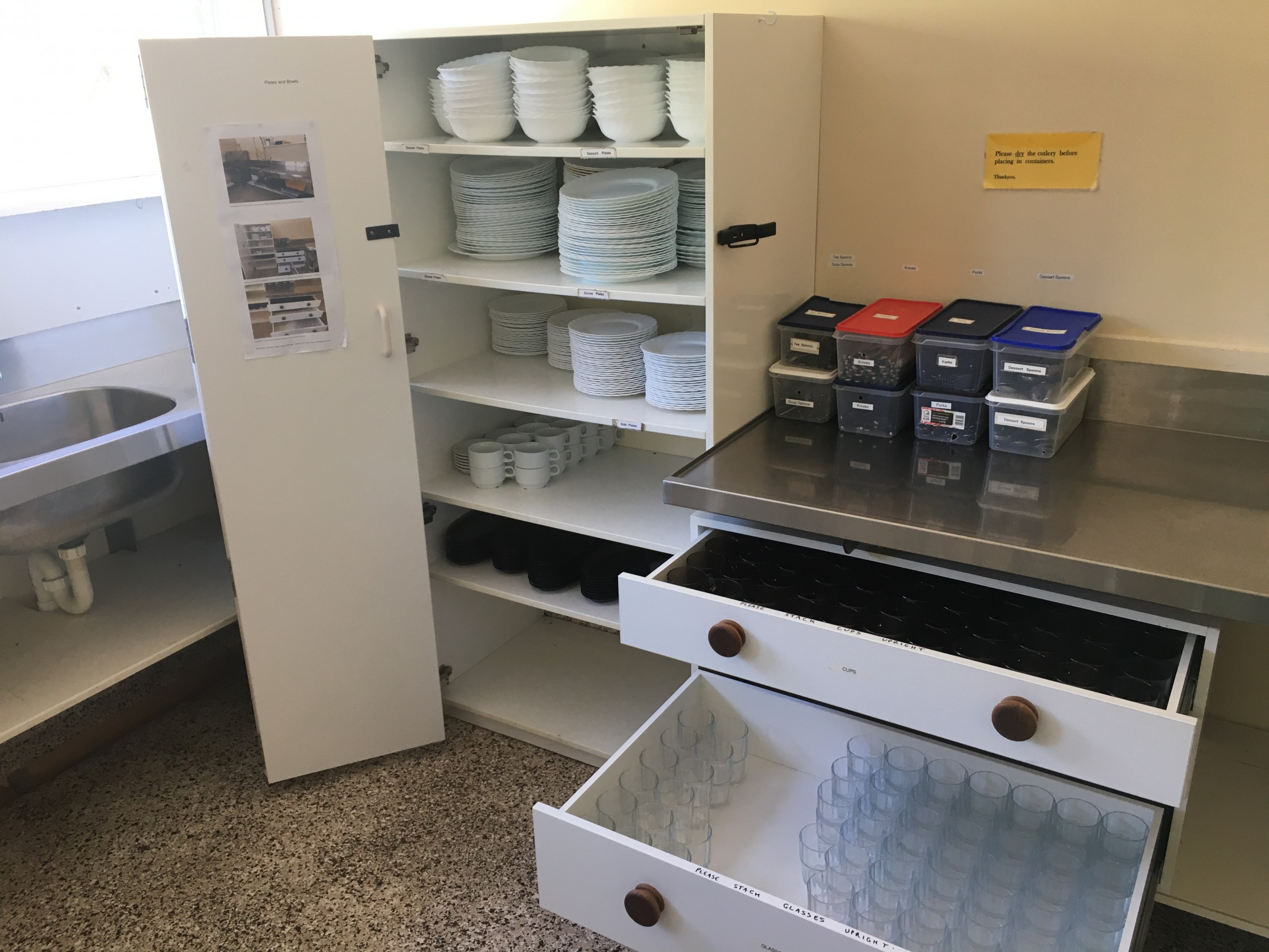 Plates, bowls, glasses, cups and cutlery in the scullery